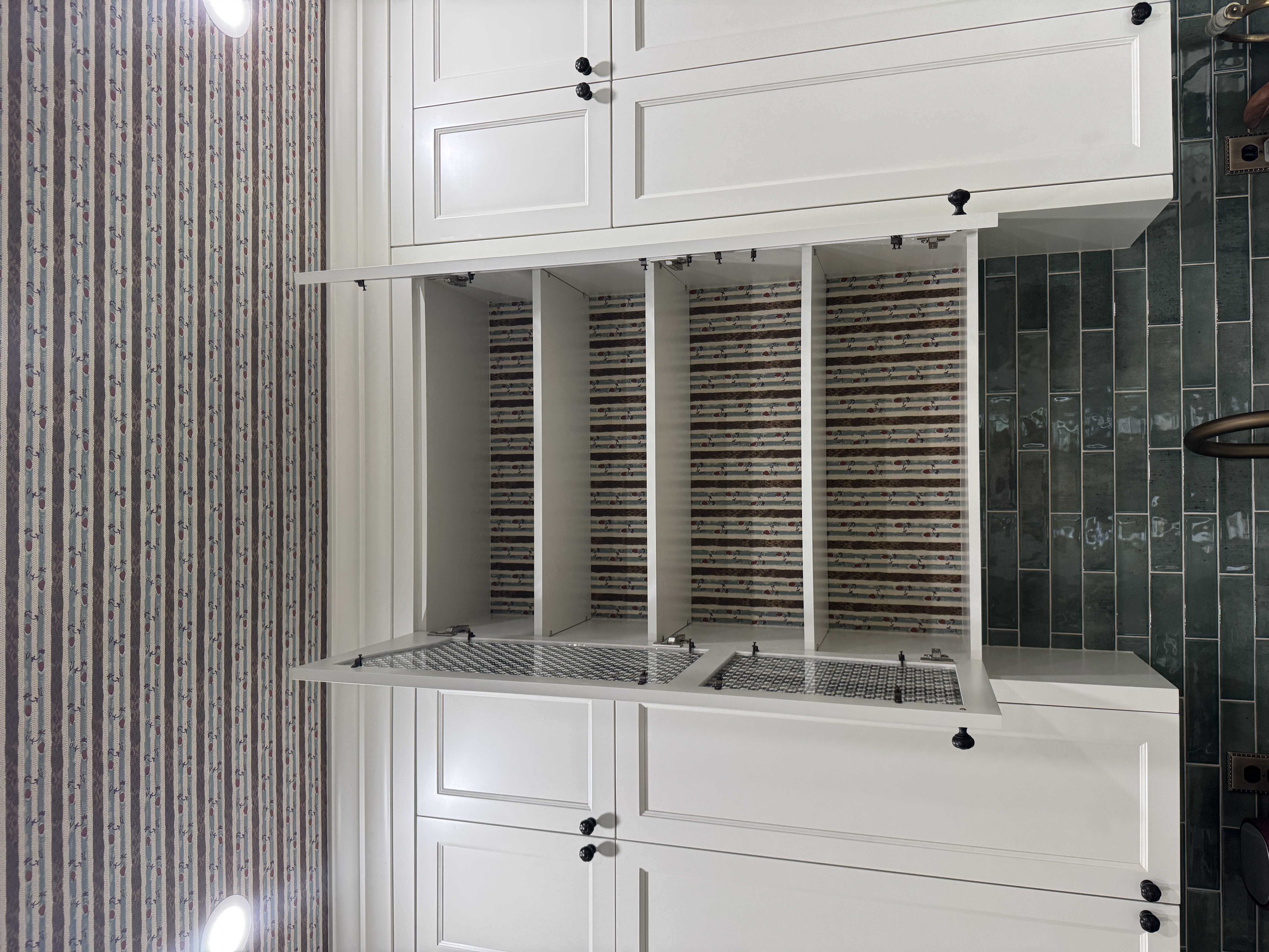 Striped wallpaper installed on a ceiling and inside kitchen cabinetry